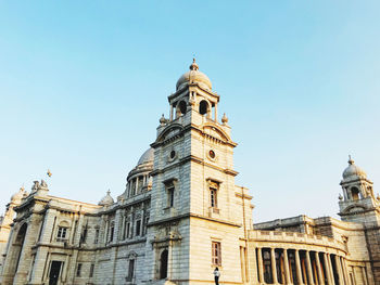 Low angle view of building against clear blue sky