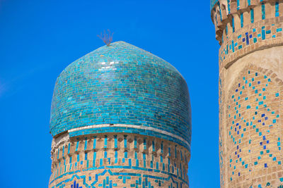 Low angle view of historical building against clear blue sky