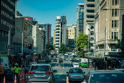 Vehicles on road against buildings in city