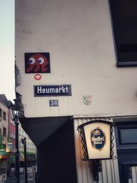 Low angle view of road sign against building