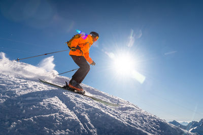 Good skiing in snowy mountains. a nice winter day, an incredible ski drive from which a skier jumps