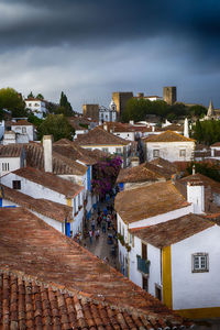 High angle view of houses against cloudy sky at obidos
