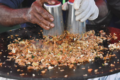 Mid section of man preparing kuttu paratha