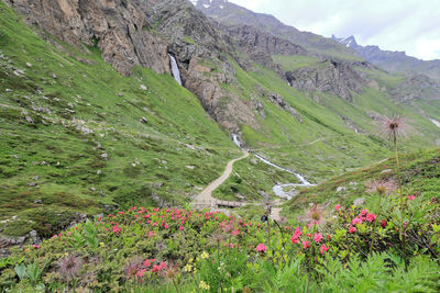 Scenic view of land and mountains against sky