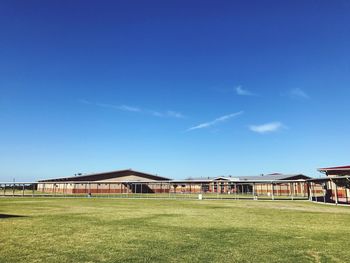 Built structure on field against blue sky