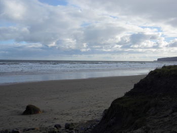 Scenic view of sea against cloudy sky