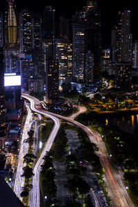 High angle view of illuminated city street at night with traffic