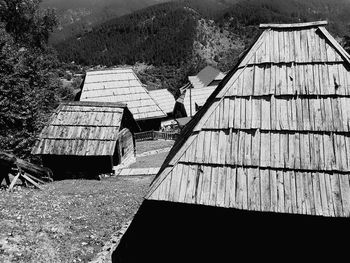 Tilt image of roof and tree against mountain