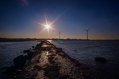 Scenic view of sea against bright sun