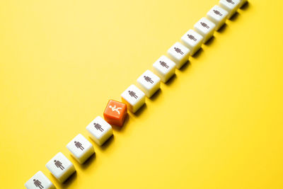 Close-up of thermometer on yellow background