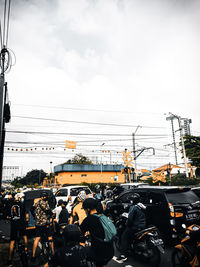 Group of people in city against sky