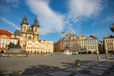 Buildings in city against cloudy sky