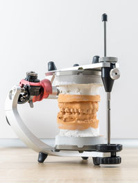 Close-up of machinery on table against white background