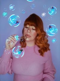 Portrait of young woman in bubbles