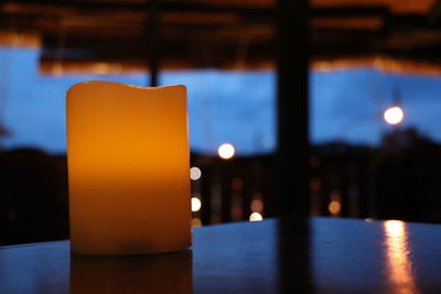 Close-up of illuminated candles on table