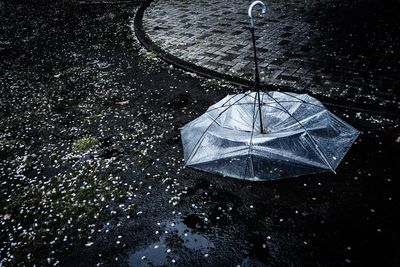 High angle view of raindrops on umbrella