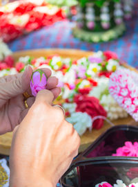 Close-up of hand holding flower bouquet