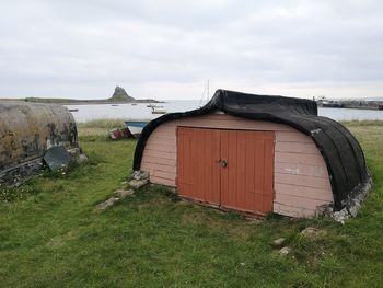 Built structure on field against sky