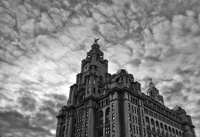 Low angle view of royal liver building against cloudy sky