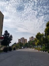 City street by buildings against sky