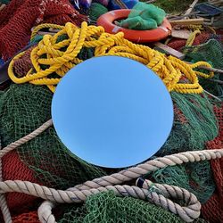 Nautical gear and the sky through a hole mirror 