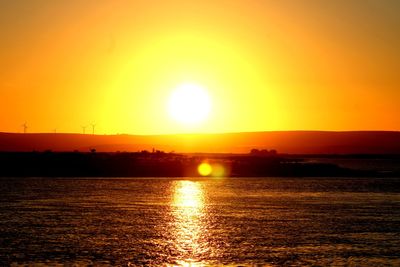 Scenic view of sea against orange sky