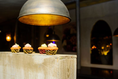 Cupcakes prestend on a wooden block in a warm design interieur on a party