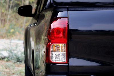 Close-up of red car on road