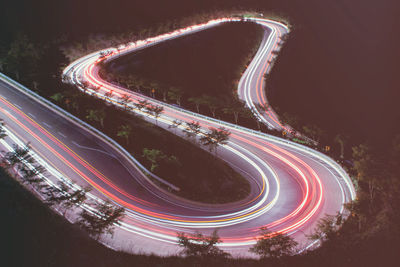 High angle view of light trails on road at night