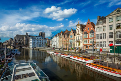 Bridge over river in city against sky