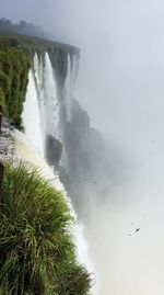 Scenic view of waterfall against clear sky