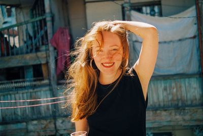 Portrait of smiling young woman with tousled hair