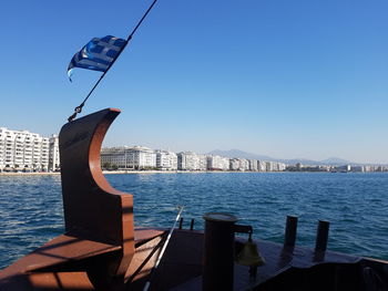 City at waterfront against blue sky