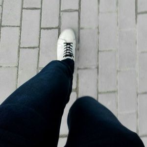 Low section of man standing on footpath