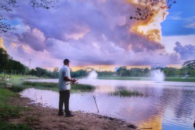 Full length of man standing by water against sky