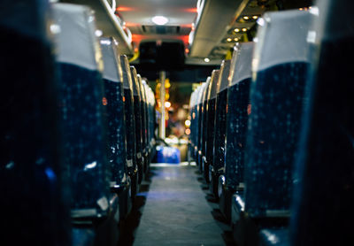 Empty seats in illuminated bus at night