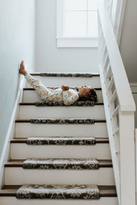 Low angle view of woman lying down on staircase