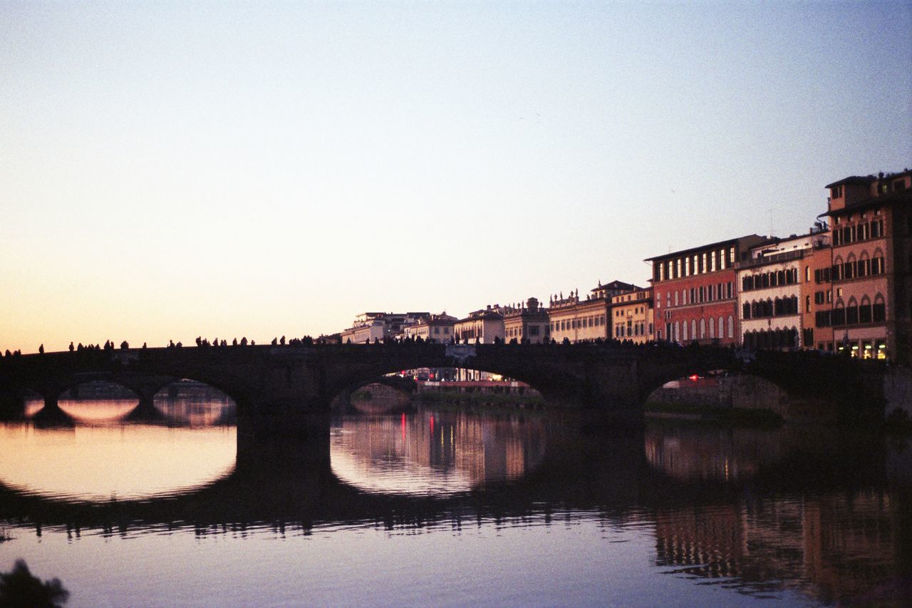 BRIDGE OVER RIVER AGAINST CLEAR SKY IN CITY