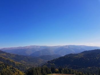 Scenic view of mountains against clear blue sky