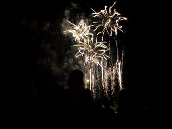 Low angle view of firework display at night