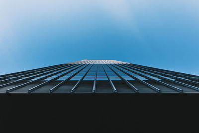 Low angle view of modern building against blue sky