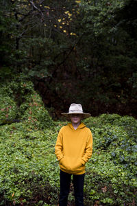 Portrait of boy wearing large fedora in nature