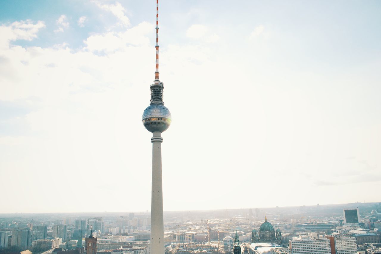 architecture, building exterior, built structure, tower, communications tower, city, tall - high, spire, capital cities, international landmark, cityscape, travel destinations, famous place, tourism, television tower, skyscraper, fernsehturm, travel, sky, communication