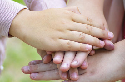 Close-up of children stacking hands