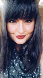 Close-up portrait of smiling young woman