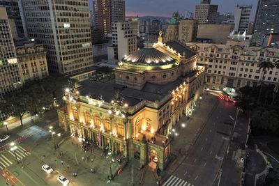 High angle view of illuminated buildings in city at night