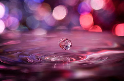 Close-up of drop falling on water