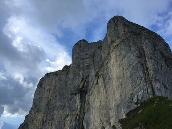 Low angle view of rocky mountain against sky