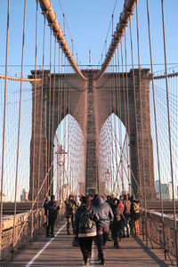 People walking on suspension bridge