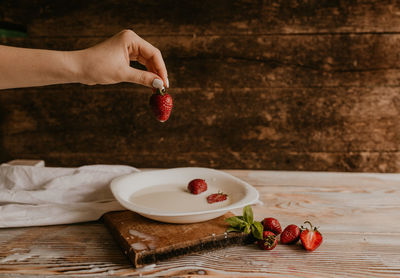 Cropped hands of person preparing food on table